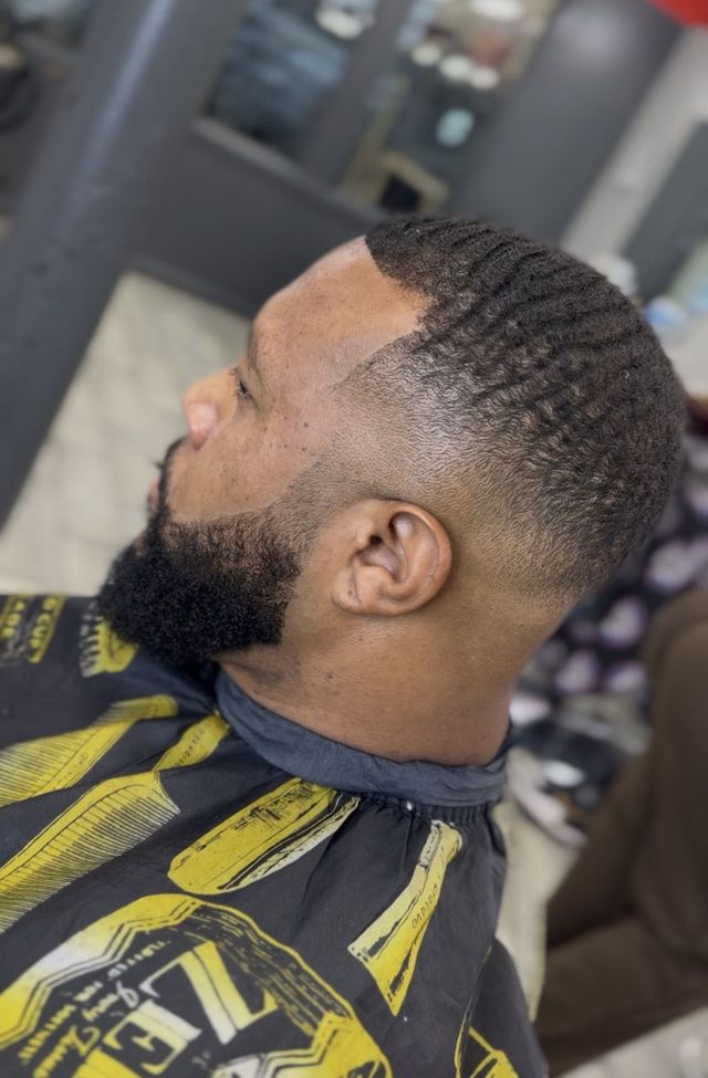 Real client profile with hair waves, mid fade and a full lined-up beard